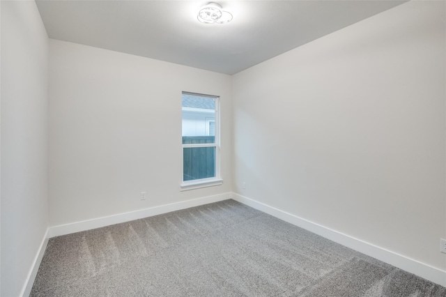 carpeted spare room with baseboards