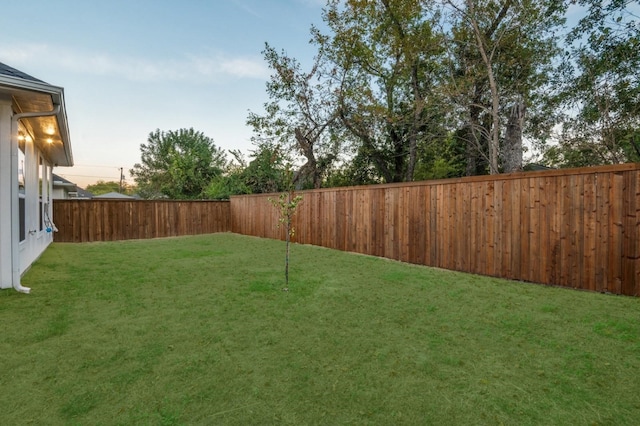 view of yard with a fenced backyard