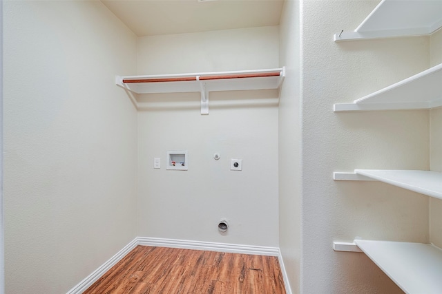 laundry room with hookup for a gas dryer, hookup for an electric dryer, laundry area, washer hookup, and wood finished floors