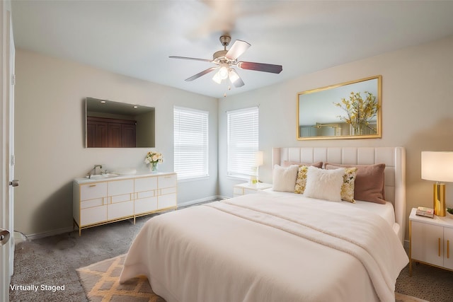 carpeted bedroom featuring a ceiling fan and baseboards