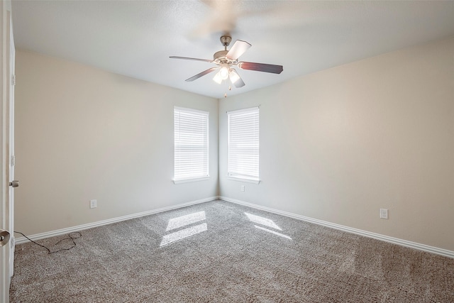 unfurnished room featuring ceiling fan, carpet floors, and baseboards