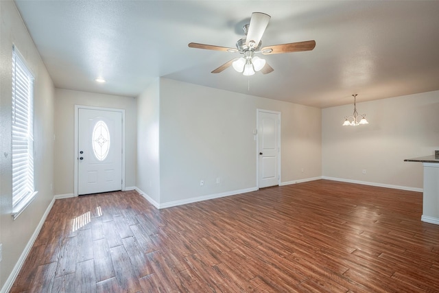 foyer entrance featuring baseboards, wood finished floors, and ceiling fan with notable chandelier