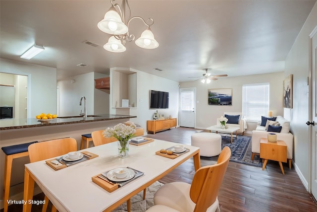 dining space with dark wood-style floors, visible vents, and a ceiling fan