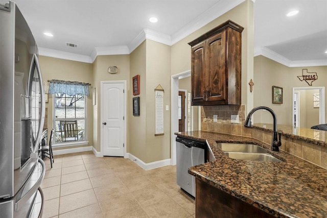 kitchen featuring visible vents, appliances with stainless steel finishes, a sink, and ornamental molding