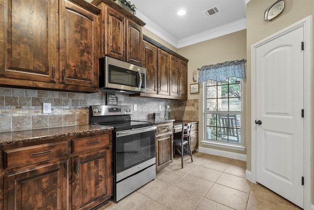 kitchen featuring visible vents, decorative backsplash, appliances with stainless steel finishes, crown molding, and light tile patterned flooring