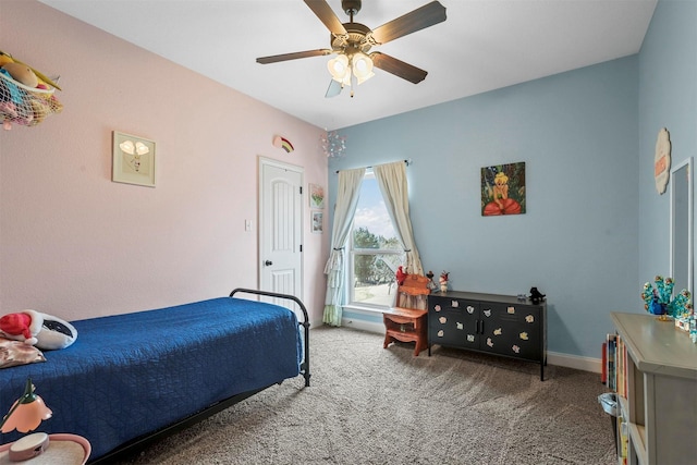 carpeted bedroom with ceiling fan and baseboards