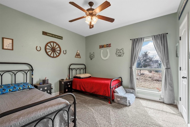 bedroom featuring a ceiling fan, carpet, and baseboards