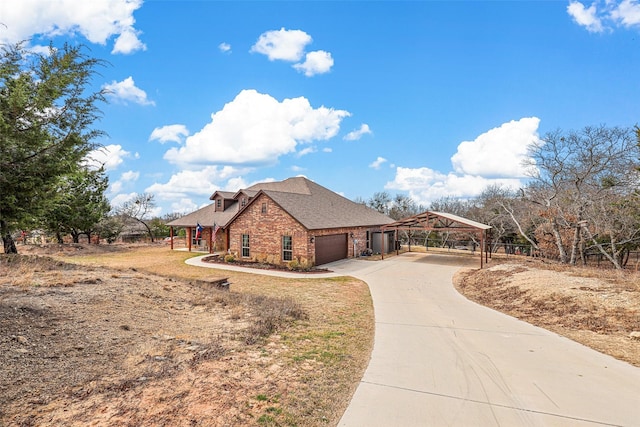 view of front of property featuring an attached garage, concrete driveway, and a gazebo