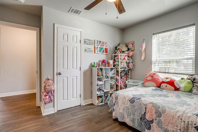 bedroom featuring visible vents, ceiling fan, baseboards, and wood finished floors