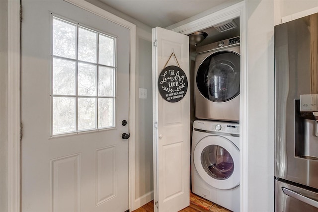 clothes washing area with laundry area and stacked washer and clothes dryer