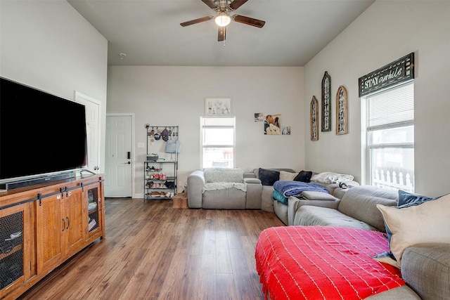 living area with a healthy amount of sunlight, a ceiling fan, and wood finished floors