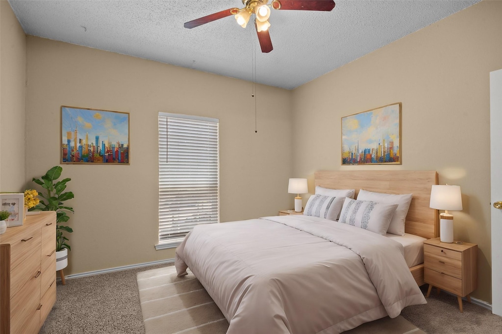 1700 Amelia Ct Unit 221, Plano, TX 75075 - bedroom featuring a textured ceiling, ceiling fan, carpet flooring, and baseboards