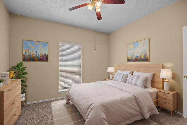 bedroom featuring a textured ceiling, ceiling fan, carpet flooring, and baseboards