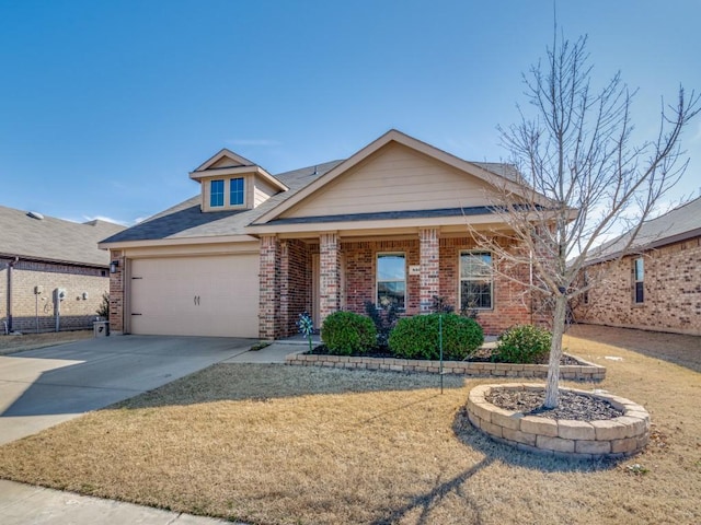 view of front of home featuring a garage, a front yard, brick siding, and driveway