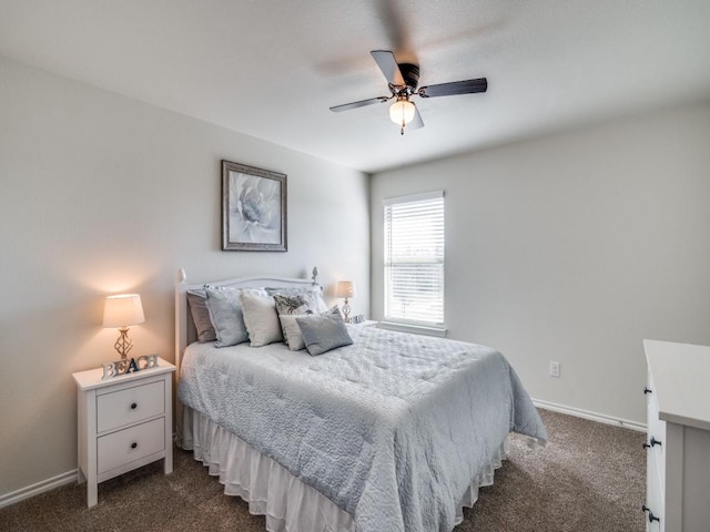 bedroom with ceiling fan, baseboards, and dark colored carpet