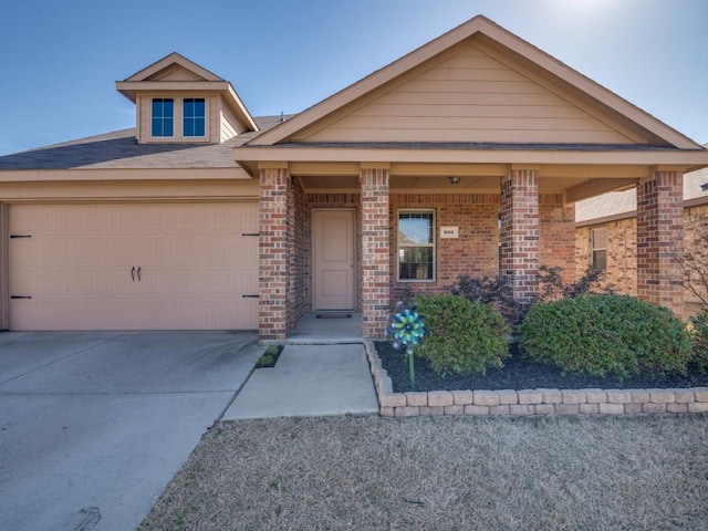 view of front of house featuring concrete driveway, brick siding, and an attached garage