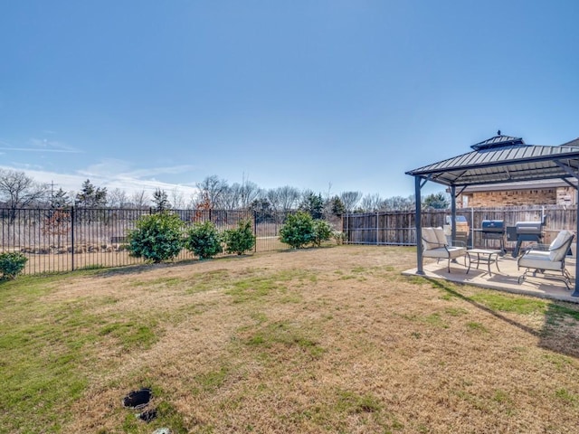 view of yard featuring a patio area, a fenced backyard, and a gazebo