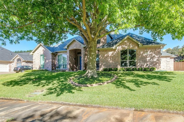 single story home featuring a front lawn and brick siding