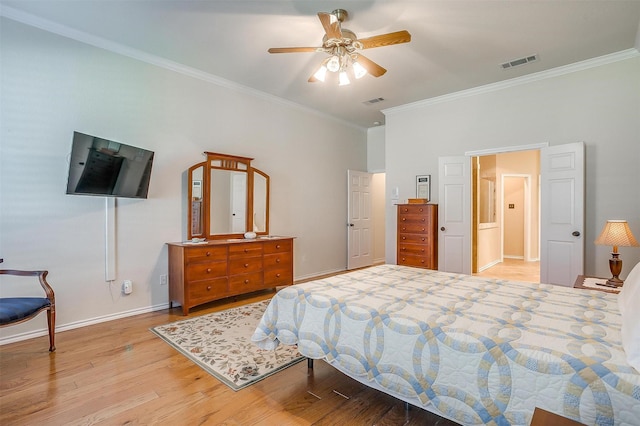 bedroom with ceiling fan, wood finished floors, visible vents, baseboards, and crown molding