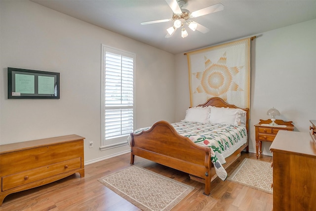 bedroom featuring light wood-type flooring, multiple windows, and ceiling fan