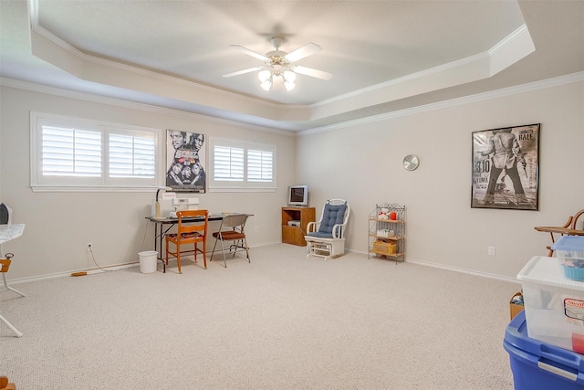 recreation room featuring ornamental molding, a tray ceiling, and baseboards