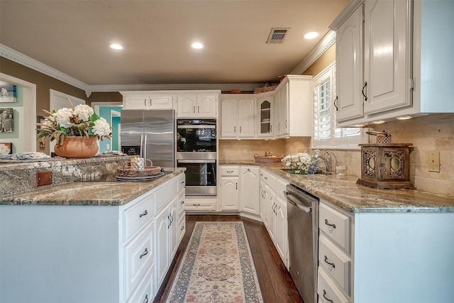 kitchen featuring white cabinetry, visible vents, stainless steel appliances, and dark wood finished floors