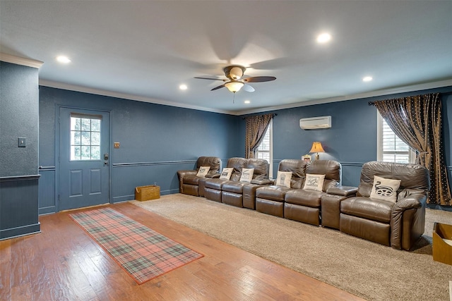 home theater featuring ceiling fan, wood finished floors, a wall mounted air conditioner, crown molding, and recessed lighting