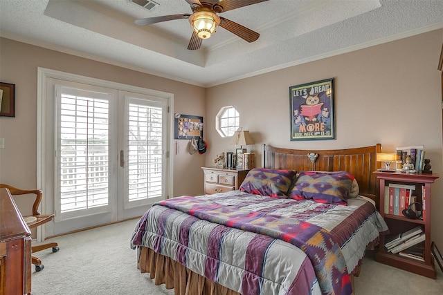 bedroom featuring access to exterior, a raised ceiling, carpet flooring, and ornamental molding