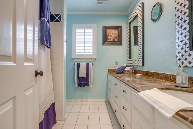 bathroom featuring visible vents, baseboards, tile patterned flooring, crown molding, and vanity