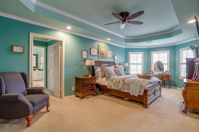 bedroom featuring light carpet, baseboards, a tray ceiling, and ornamental molding