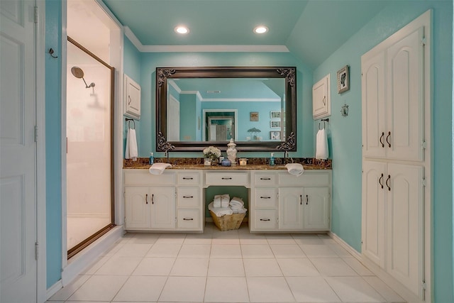 full bathroom featuring ornamental molding, tile patterned flooring, a shower stall, and double vanity