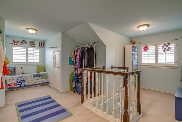 carpeted bedroom featuring baseboards