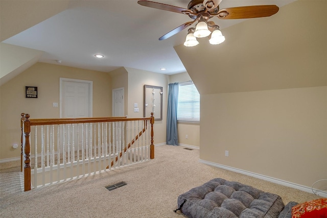 additional living space with carpet, baseboards, visible vents, and vaulted ceiling