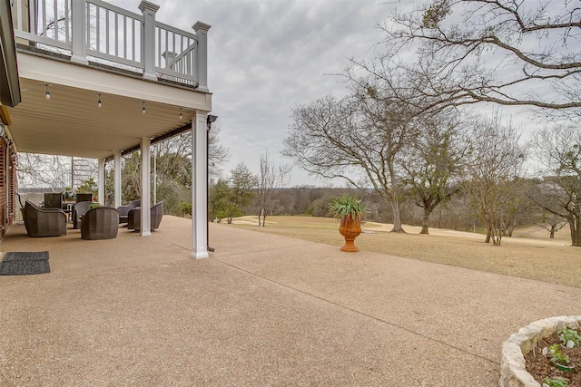 view of patio featuring a balcony