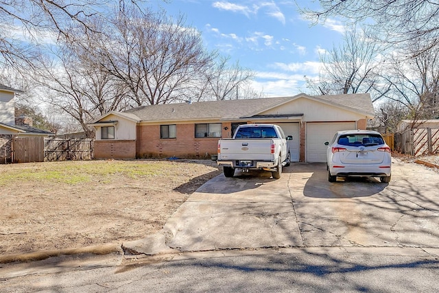 single story home with concrete driveway, brick siding, fence, and an attached garage