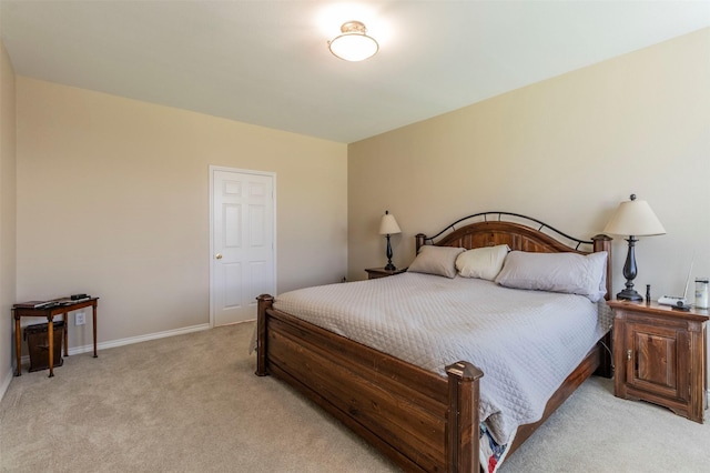 bedroom with light carpet and baseboards