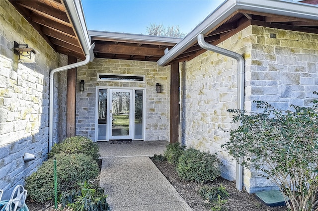 entrance to property featuring stone siding