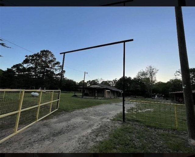 exterior space featuring a front lawn, fence, and a gate