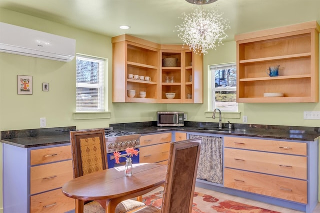 kitchen featuring a wall mounted air conditioner, stainless steel appliances, a healthy amount of sunlight, and a sink