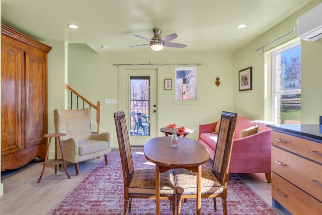 dining room with a wall mounted AC, recessed lighting, ceiling fan, stairs, and light wood-style floors