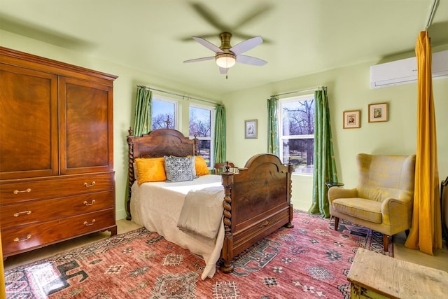 carpeted bedroom featuring a wall mounted AC and a ceiling fan