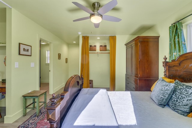 bedroom featuring a closet, baseboards, and ceiling fan