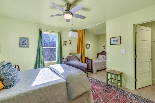 bedroom with wood finished floors, a ceiling fan, and a wall unit AC