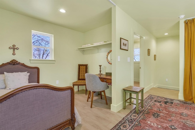 bedroom featuring recessed lighting, baseboards, and multiple windows