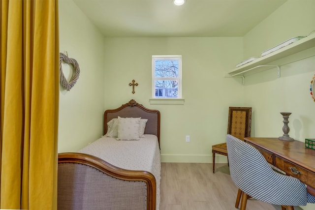 bedroom with baseboards and wood finished floors