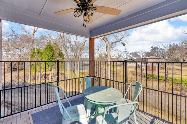 balcony featuring outdoor dining area and a ceiling fan