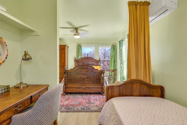 bedroom featuring an AC wall unit and wood finished floors