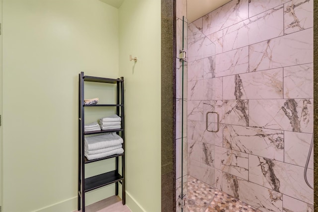 full bath featuring baseboards and a shower stall