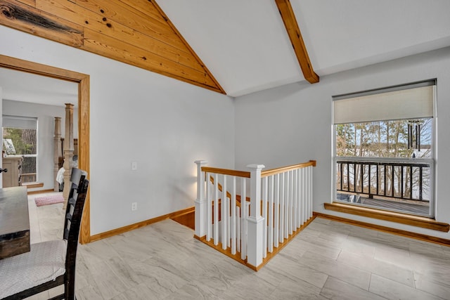 hall with vaulted ceiling with beams, baseboards, and an upstairs landing