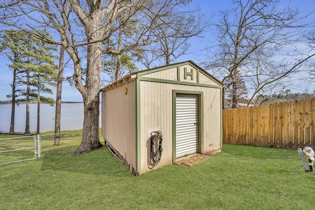 view of shed featuring a water view and a fenced backyard